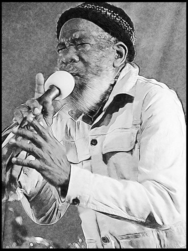 Black and white stylized photograph of Walford “Poko” Tyson, performing with a microphone in an expressive pose. He wears a distinctive patterned headband and a light-colored button-up shirt while singing passionately during a live performance.
